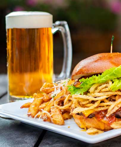 Close up shot of a burger and glass of beer.
