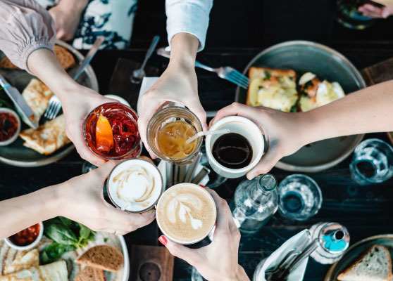 group of friends toasting over a table with a brunch setting