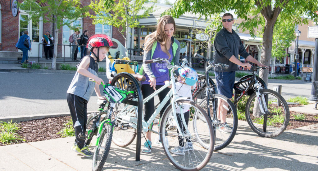 family of four parking their bikes in Historic Folsom