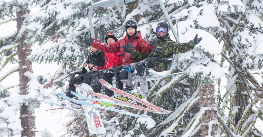 group of friends on a lift in the snow