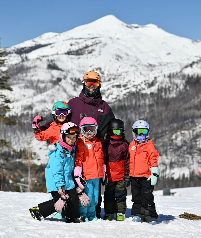 family posing in the snow