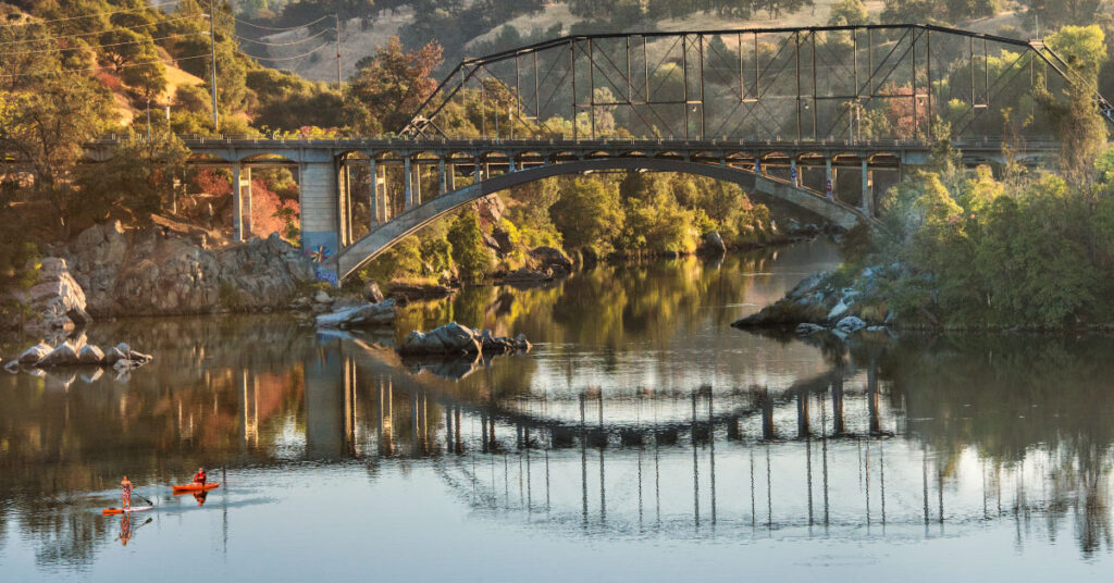 kayaker and paddleboarder on lake natoma