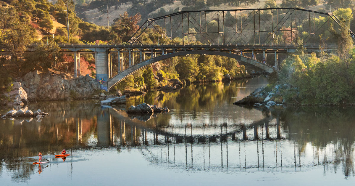 kayaker and paddleboarder on lake natoma
