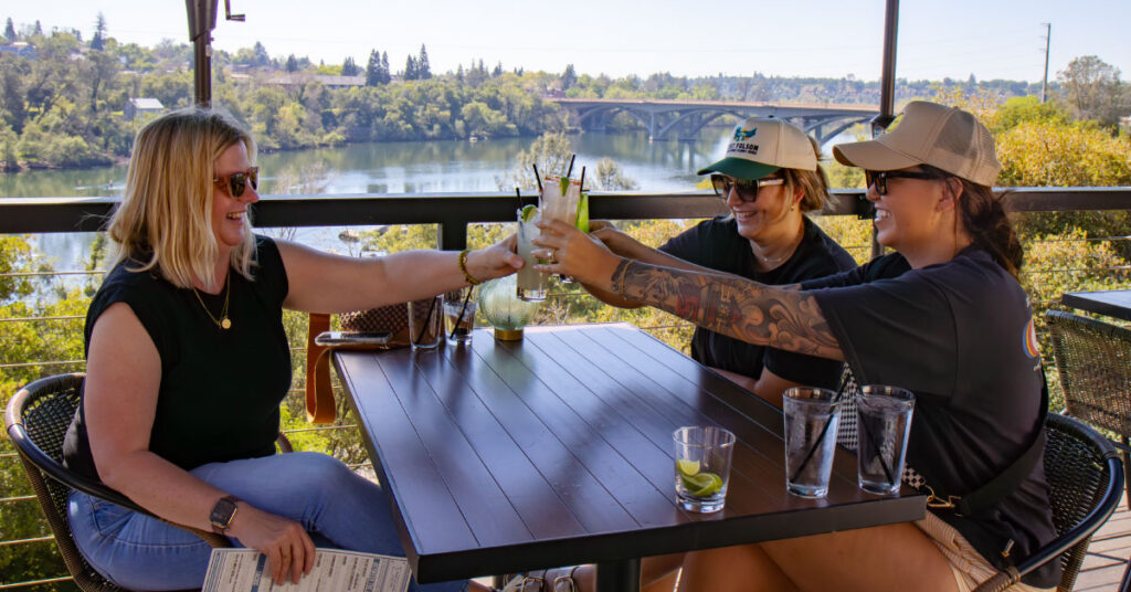 Three women cheersing at Crawdads