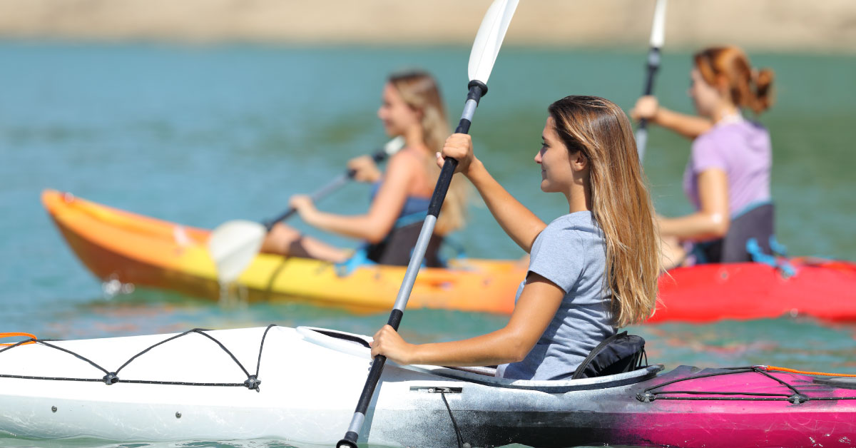 girls kayaking together