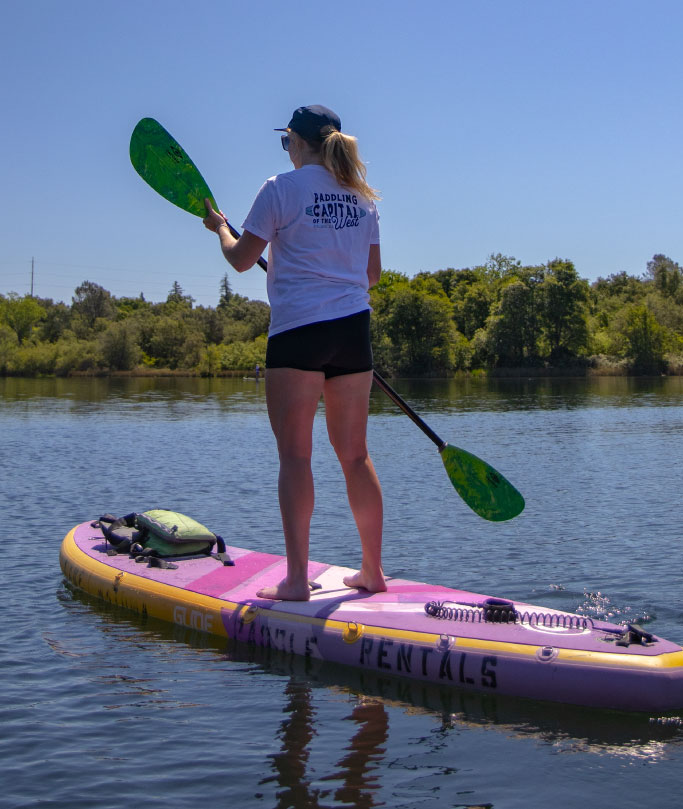 girl standup paddle boarding
