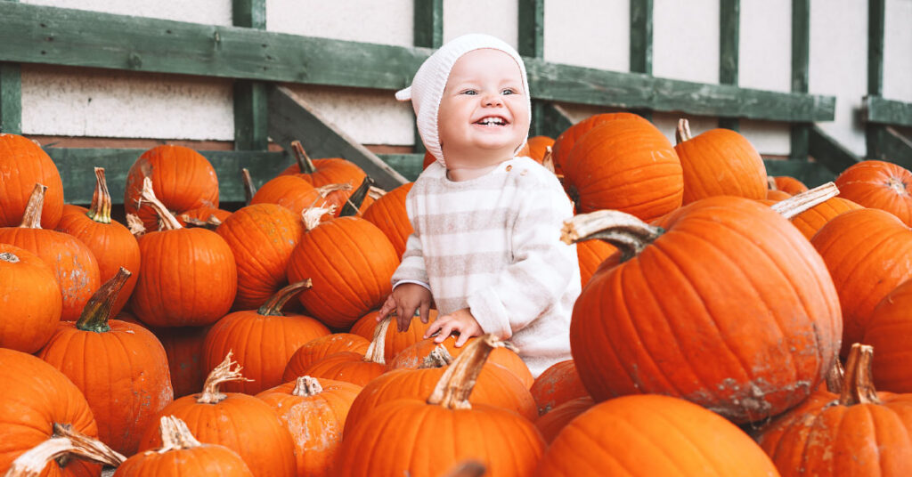 Baby surrounded by pumpkins