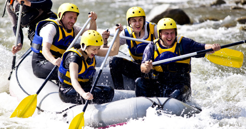 group of people on a raft going down a river