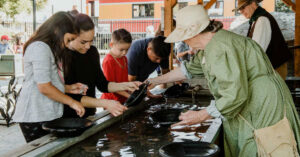 group pf kids panning for gold at the Square