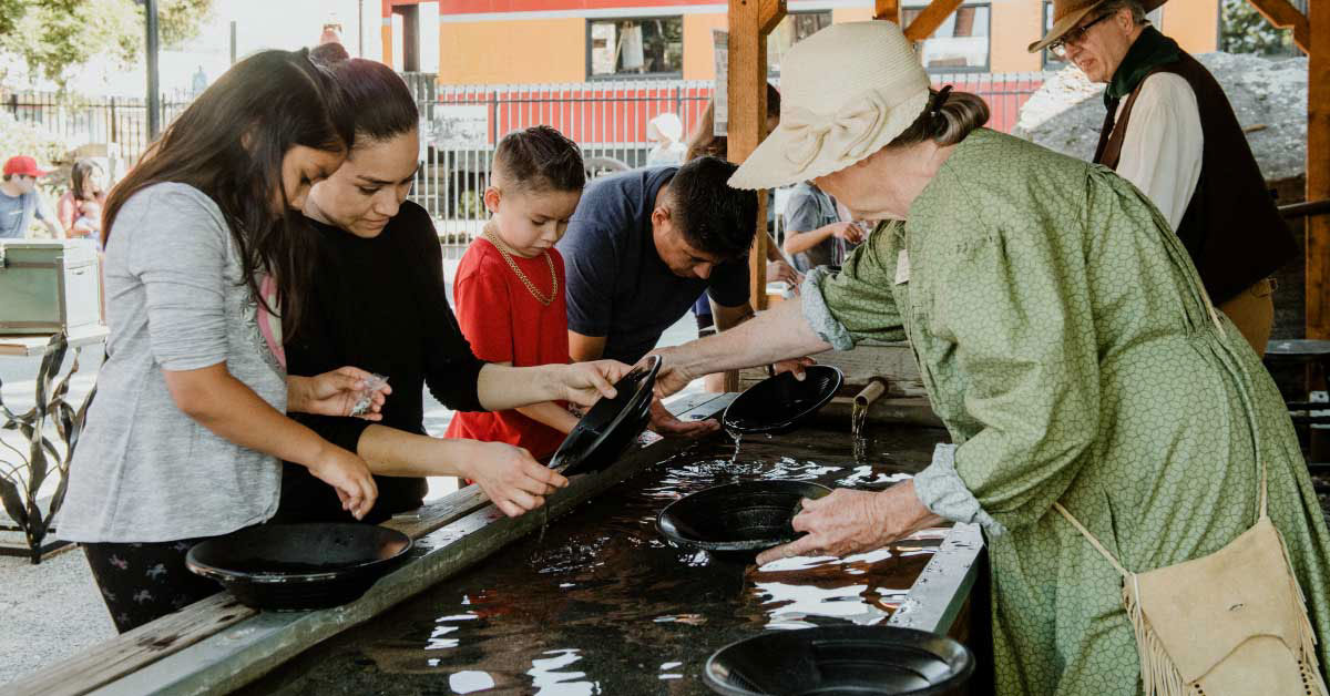 group pf kids panning for gold at the Square