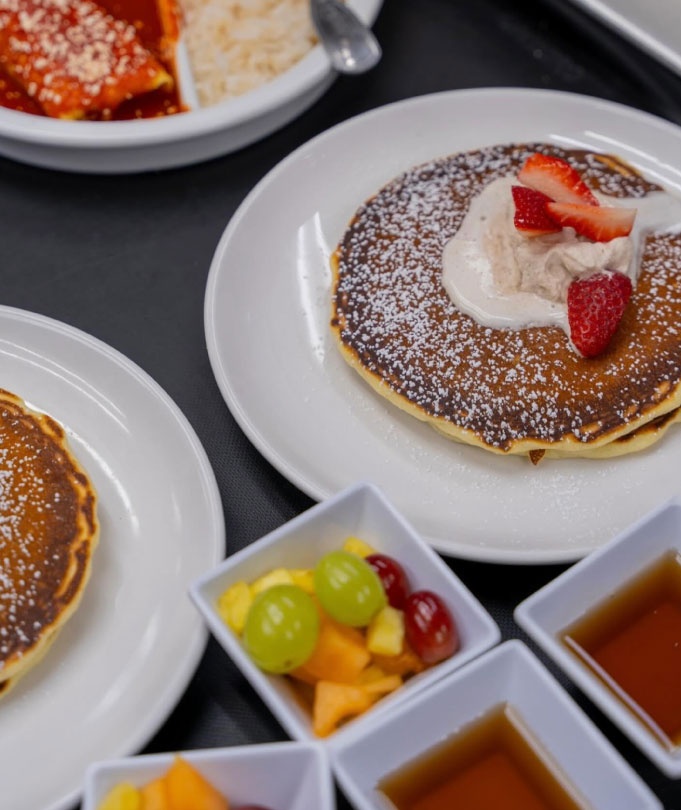 pancakes with powdered sugar and strawberries